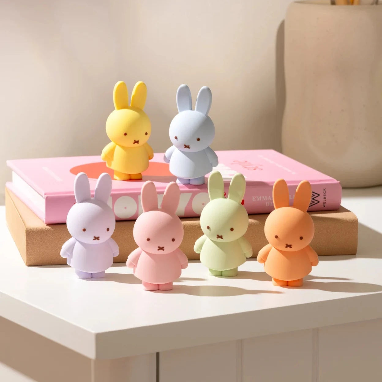 Colorful rabbit-shaped desk organizers on a white surface with a neutral background