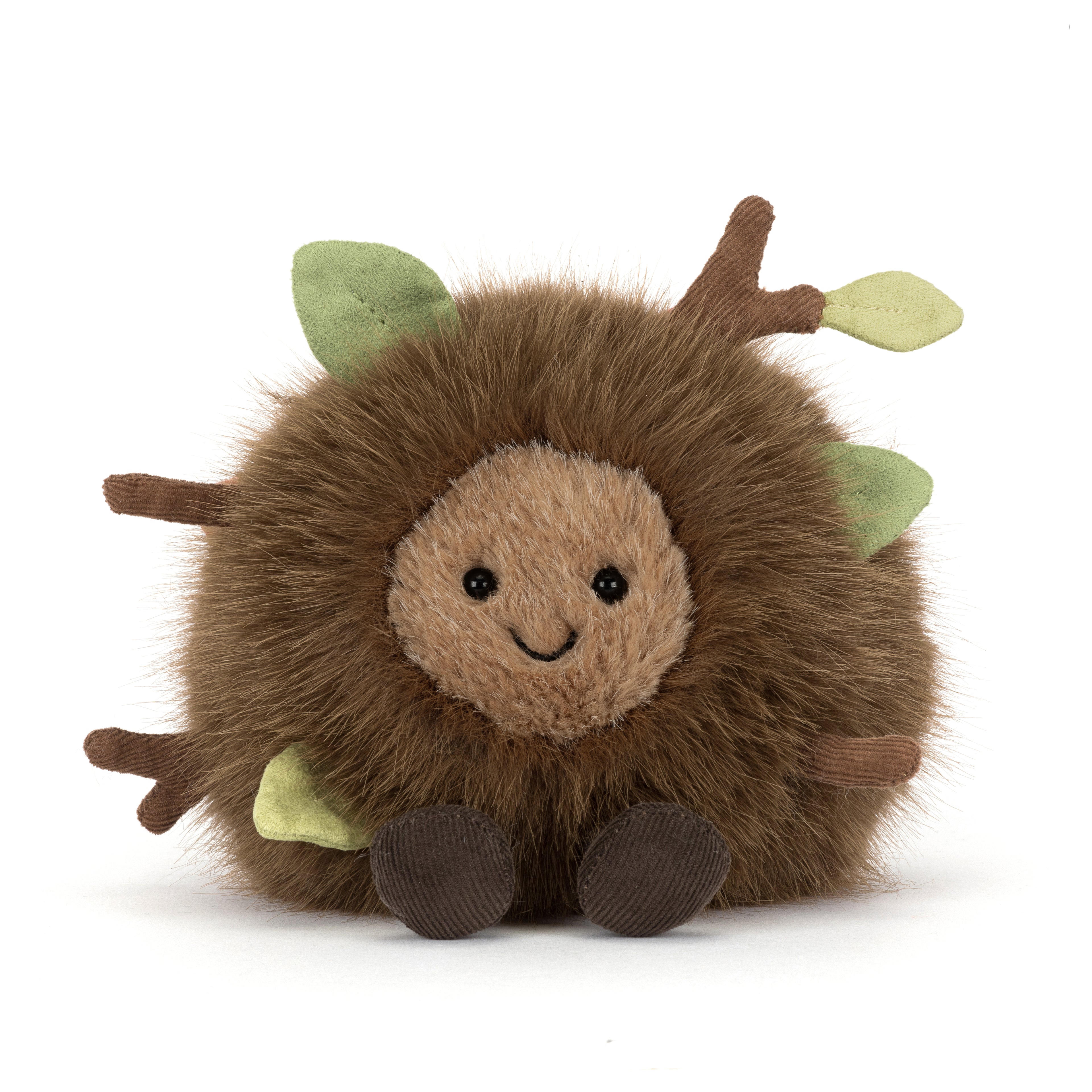 Plush toy hedgehog with green leaves on a white background