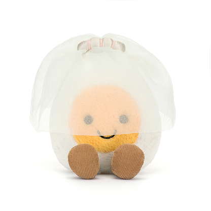 Round plush egg with a smiling face  wearing a bridal veil on a white background