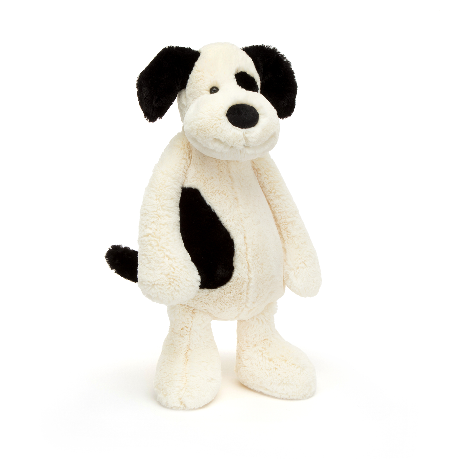 Black and white plush dog toy on a white background