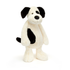 Black and white plush dog toy on a white background