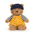 Teddy bear wearing a navy hat, striped shirt, and yellow overalls on a white background