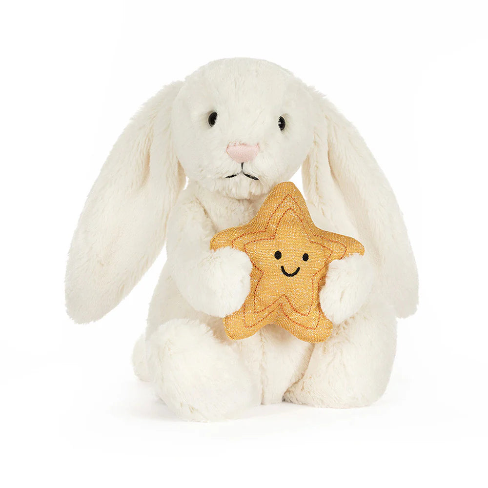 White plush bunny holding a star-shaped cookie with a smiley face on a white background