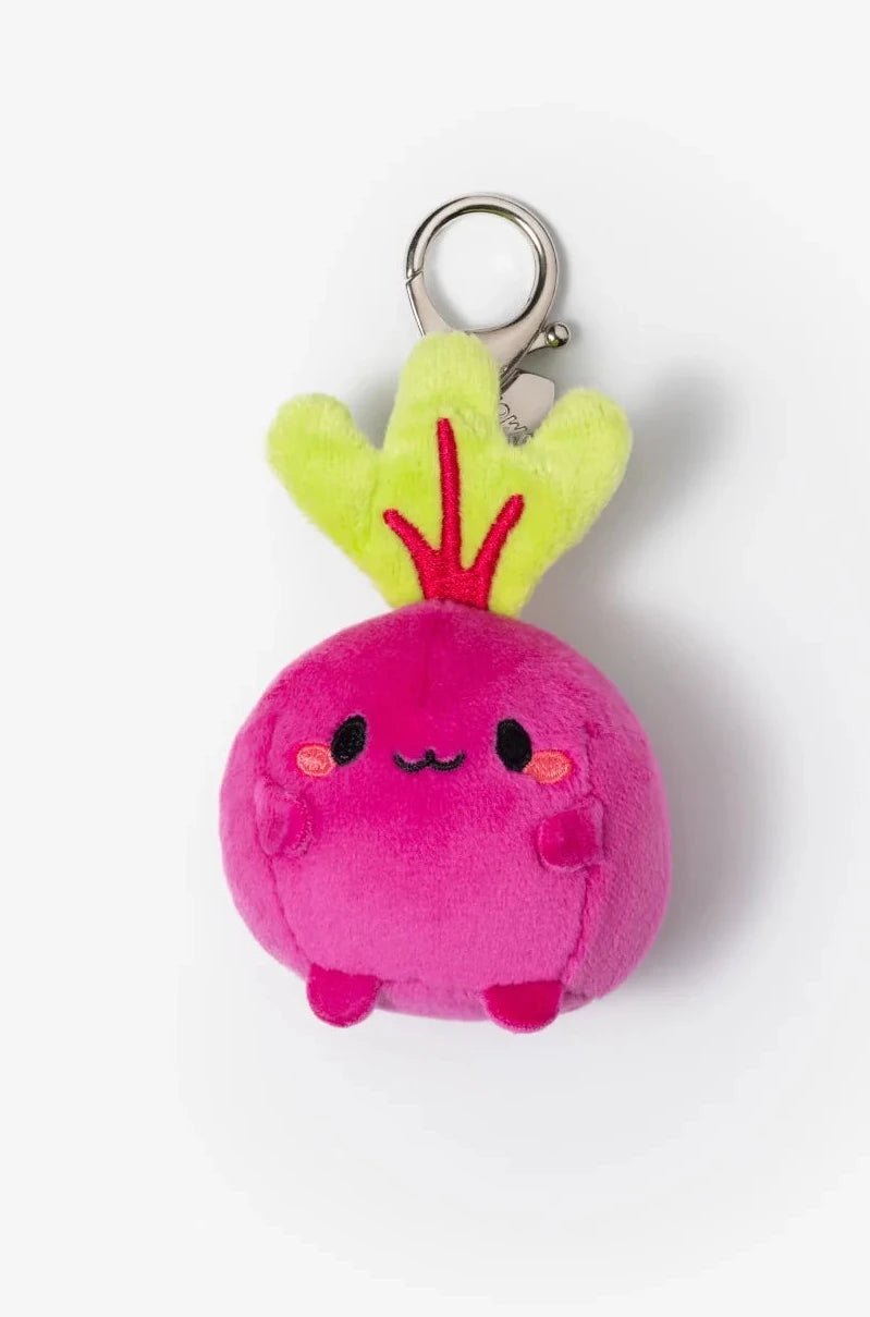 Pink plush beet keychain with yellow leaves on a white background