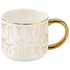 White mug with gold handles and decorative bows on a white background