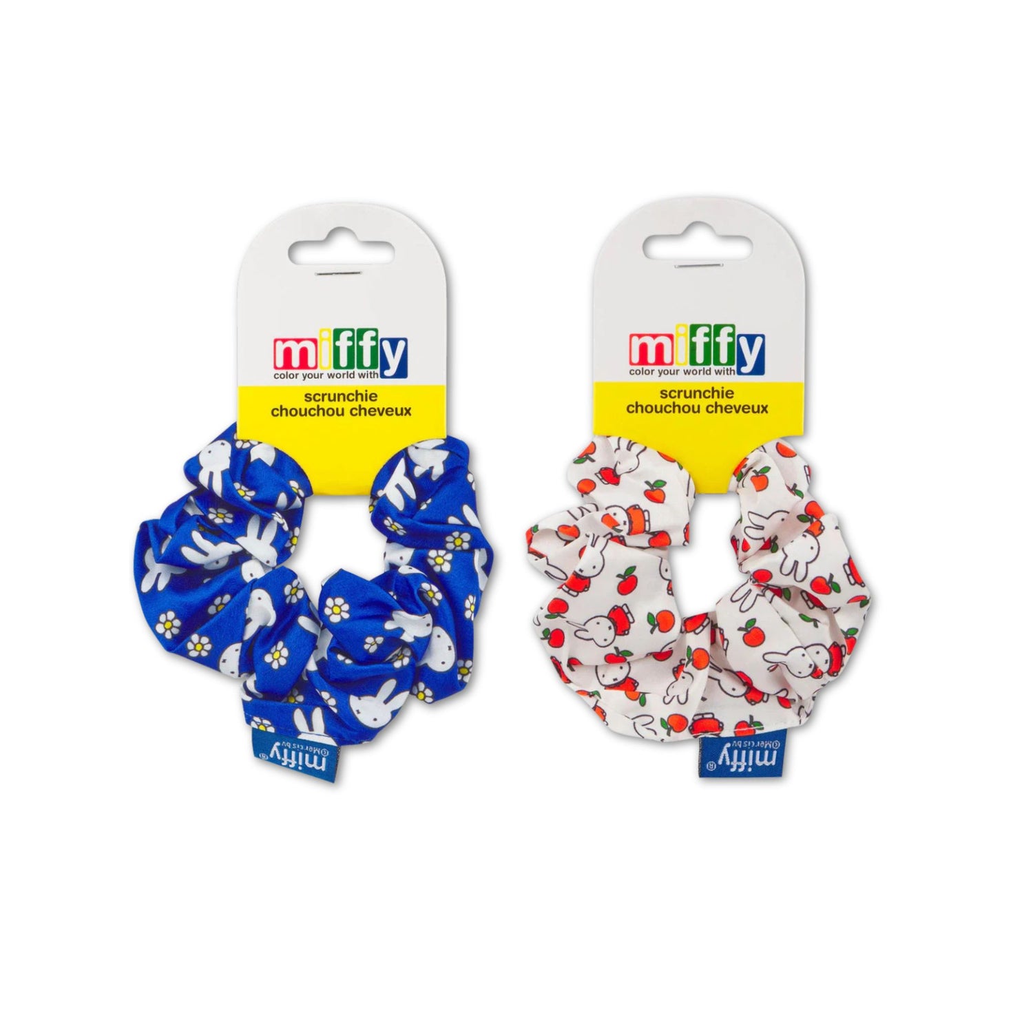 Two Miffy scrunchies on packaging with blue and white floral design and red and white strawberry design.