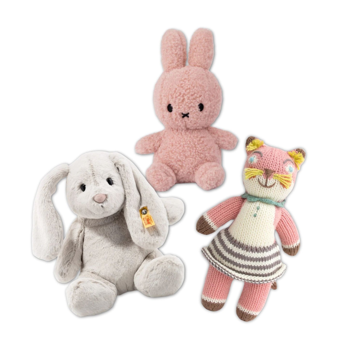 Three plush toys including a pink bunny, gray rabbit, and striped cat on a white background