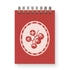 Red notebook with a white tomato design on a white background